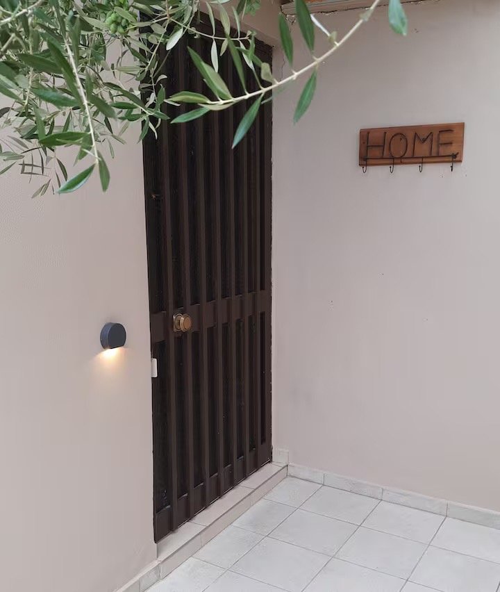 Entrance to the studio with a wooden HOME sign